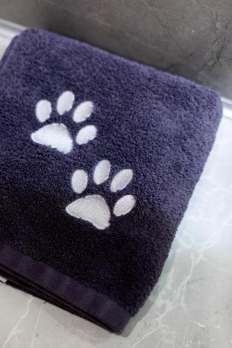 a black rug with white pawprints on it at Apartel Uzhhorod in Uzhhorod