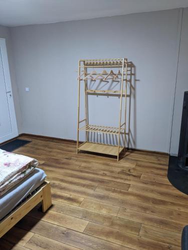 a room with a wooden floor and a metal shelf at Kleine Wohnung am waldrand in Baustert