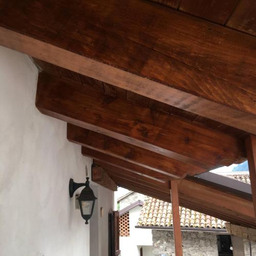 a wooden ceiling with a light on a building at Casa di Nonno Tilio in Priola