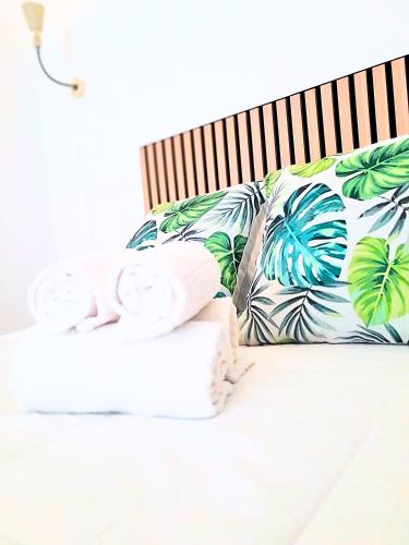 a bed with two towels on top of it at Easy4Stay in Portimão