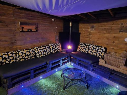 a living room with a couch and a table at Sied Yr Ardd in Ystradgynlais