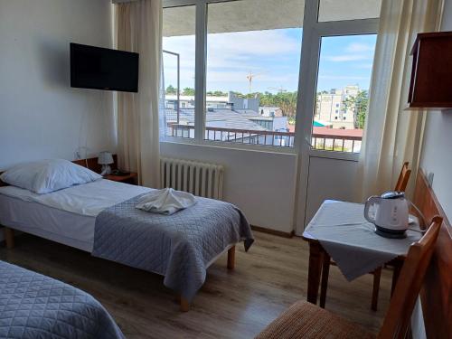 a bedroom with a bed and a window with a view at ORW Rzemieślnik in Międzywodzie