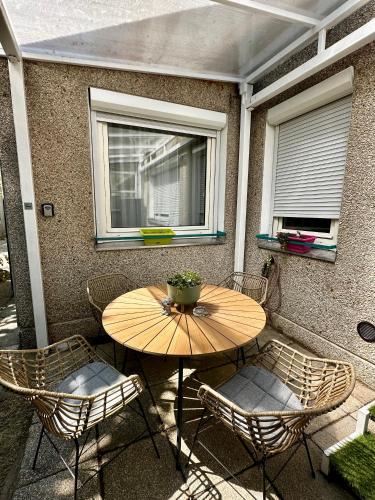 a wooden table and chairs on a patio at Római Terrace Apt in Budapest