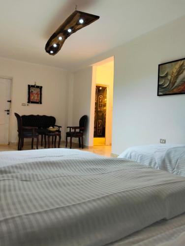 a bedroom with a bed and a table and chairs at Rafif hotel in Cairo