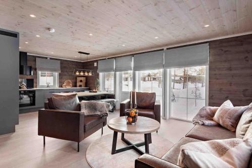 a living room with a couch and a table at New big cabin near the city centre! in Røros
