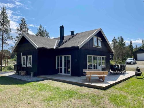 a blue house with a bench in front of it at New big cabin near the city centre! in Røros