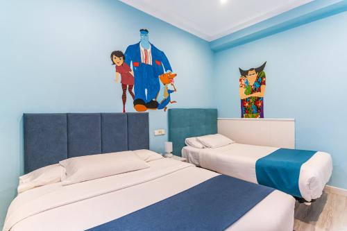 a bedroom with two beds and a painting on the wall at Hotel Mexico in Madrid