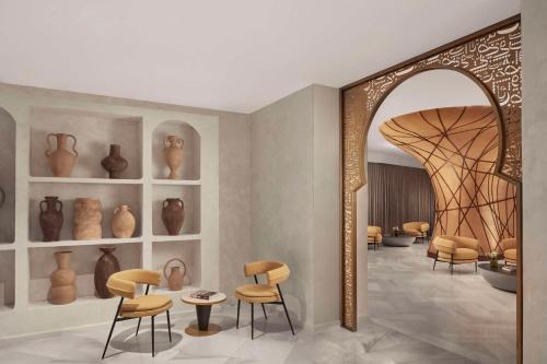 a room with vases and chairs and a mirror at NH Collection Palacio de Córdoba in Córdoba