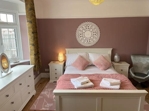 a bedroom with a bed with two pillows on it at Oak View in Saint Osyth