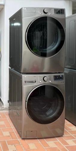 a microwave and a washing machine stacked on top of each other at Hostelfc Marly in Bogotá
