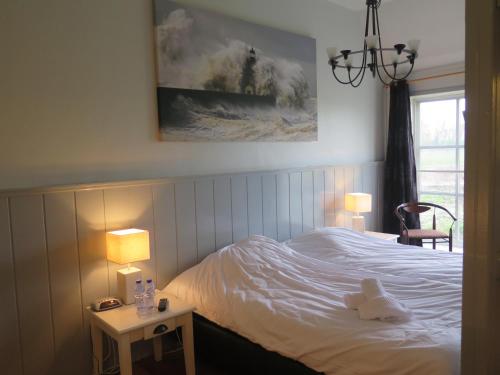 a bedroom with a bed with a teddy bear on it at Caf&eacute; Brasserie Het Heerenhuis in Het Kalf