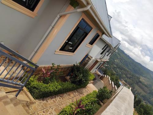 a house with stairs leading up to a window at Sweetland view hotel in Lushoto