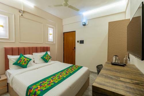 a hotel room with a bed and a table at Treebo The Tree, Hinjewadi in Pune