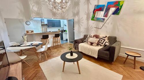 un salon avec un canapé et une table dans l'établissement Résidence cosy Les Ambassadeurs - Centre Ville Aix les Bains, à Aix-les-Bains