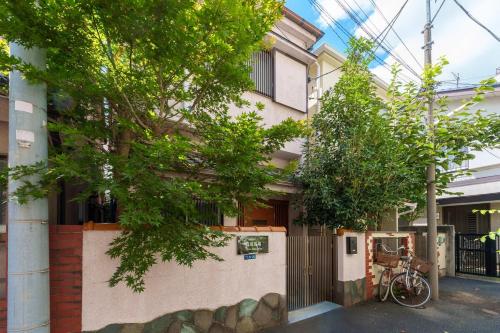 a building with trees in front of it at 楽逸グループ 高田馬場 114t in Tokyo