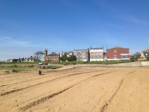 a person sitting in the middle of a dirt road at The Bakehouse in Harwich