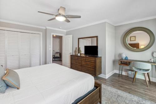 a bedroom with a bed and a mirror and a desk at Good Times and Tan Lines in Saint Joe Beach
