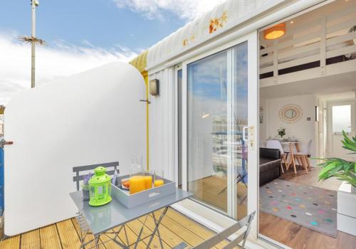 a room with a sliding glass door and a balcony at On the Water 3 A One-of-a-Kind Stay Free Parking By My Getaways in Brighton & Hove