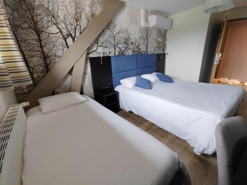a bedroom with two beds and a window at Relais Saint Michel in Saint-Michel