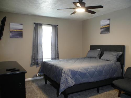 a bedroom with a bed and a ceiling fan at Family Retreat Get Away in Decatur