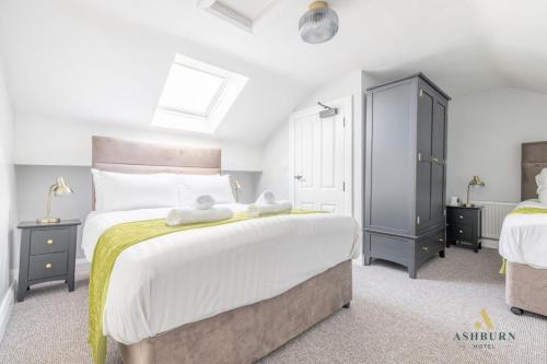 a bedroom with a large bed and two night stands at Ashburn Hotel Apartment 71A in Lurgan