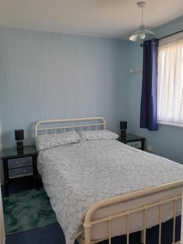 a bedroom with a bed with a white bedspread at alicias chalets ,free WIFI & swimming pool passes in Great Yarmouth