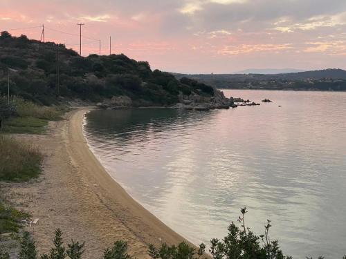 a body of water with a dirt road next to it at Casa Santa Agua in Ammouliani