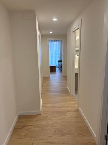 an empty hallway with wood floors in a house at REUSIA Apartaments in Reus