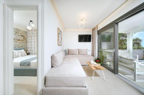 a living room with a couch and a bed at Villa Marion in Chrysi Ammoudia