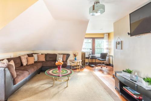 a living room with a couch and a table at Quaint 3rd Floor Loft in Highland Park