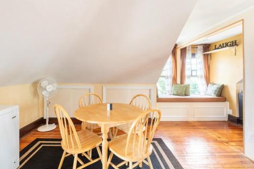 a dining room with a table and chairs and a window at Quaint 3rd Floor Loft in Highland Park