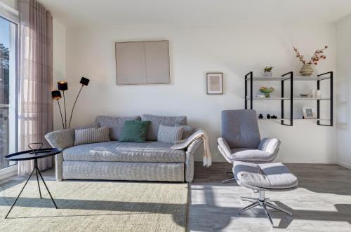 a living room with a couch and two chairs at Apartment B10 "Südbalkon mit Haffblick" im Pine Hill Resort in Zirchow