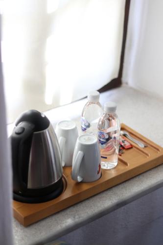 a tea kettle and cups on a wooden tray at Ha La Bodrum in Bodrum City