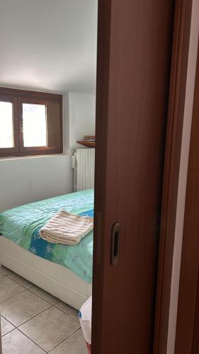 a bedroom with a bed and a window at Oasi Sole Laghi with Pool in Brebbia