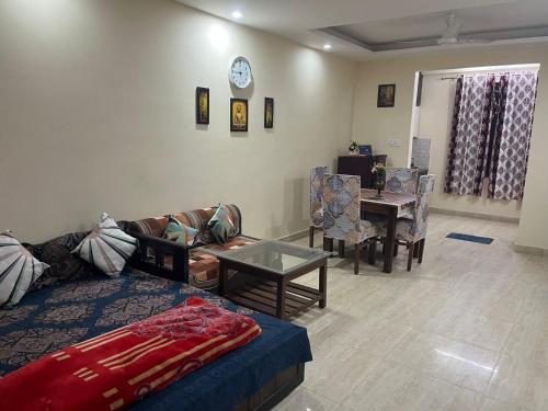 a living room with a couch and a table at Modern Luxury Deecon Valley 2BHK Flats 3Double Beds with Terrace View Tapovan Rishikesh in Rishīkesh