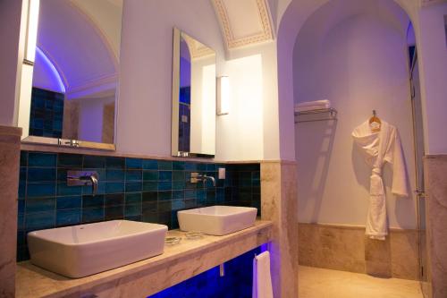 a bathroom with two sinks and a mirror at Dar Ben Turkia in Tunis