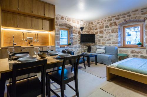 a room with a kitchen and a living room at Studio Suites Mila in Komiža