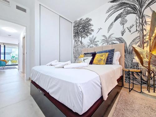 a bedroom with a large bed with a tropical wallpaper at Antilia Terraces Colibri Apartment - 5710 in Mar de Cristal