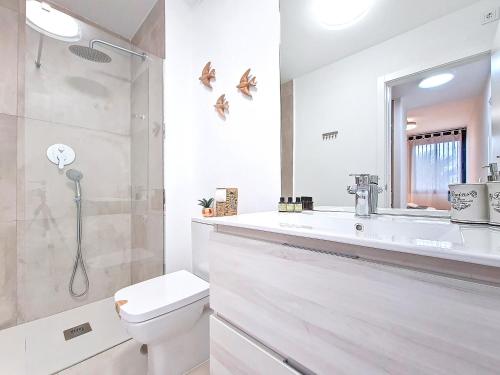 a white bathroom with a toilet and a sink at Antilia Terraces Colibri Apartment - 5710 in Mar de Cristal