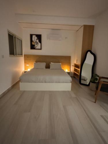 a bedroom with a bed and a large mirror at Villa Alba in Majdal Shams