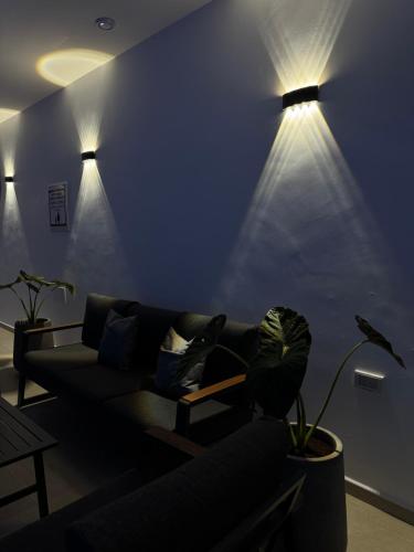 a living room with a couch and two lights at Villa Alba in Majdal Shams
