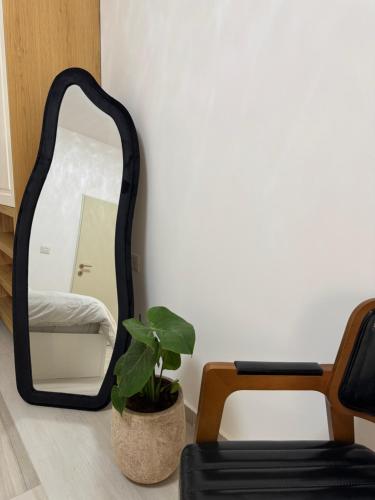 a mirror in a room with a plant and a chair at Villa Alba in Majdal Shams