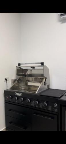 a black stove top oven with a pile of dishes at Villa Alba in Majdal Shams