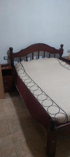 a bed in a room with a wooden frame at Mercedita in Humahuaca