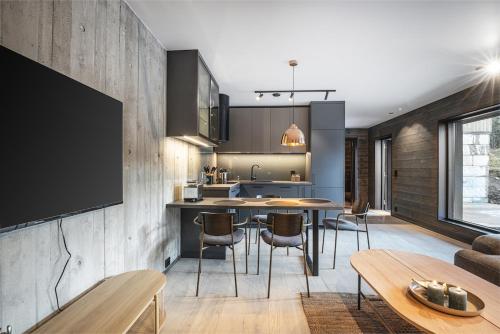 a kitchen and living room with a table and chairs at Apartment in Hemsedal in Hemsedal
