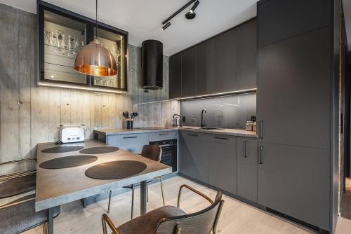 a kitchen with a table and some chairs in it at Apartment in Hemsedal in Hemsedal