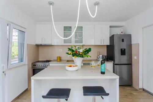 a kitchen with a white counter and a refrigerator at San Francis in Hvar