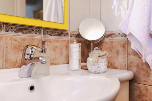 a bathroom sink with a mirror and a soap dispenser at San Francis in Hvar