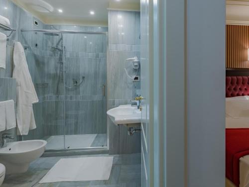 a bathroom with a shower and a sink and a toilet at La Paloma Blanca Hotel in Sciacca