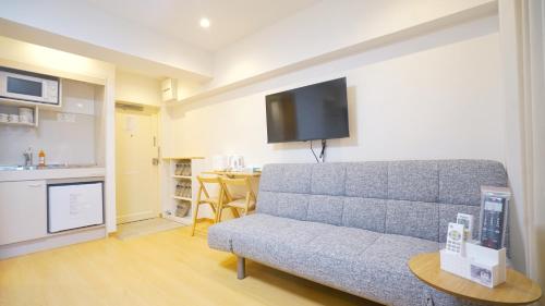 a living room with a couch and a table at Yuina Hotel Shinjuku in Tokyo